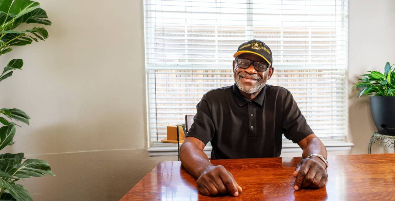 Smiling Veteran at home learning about trusted in-home care and support services from Help at Home.