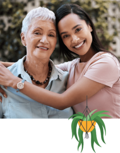 a smiling young woman with her arms around a smiling older woman's shoulders