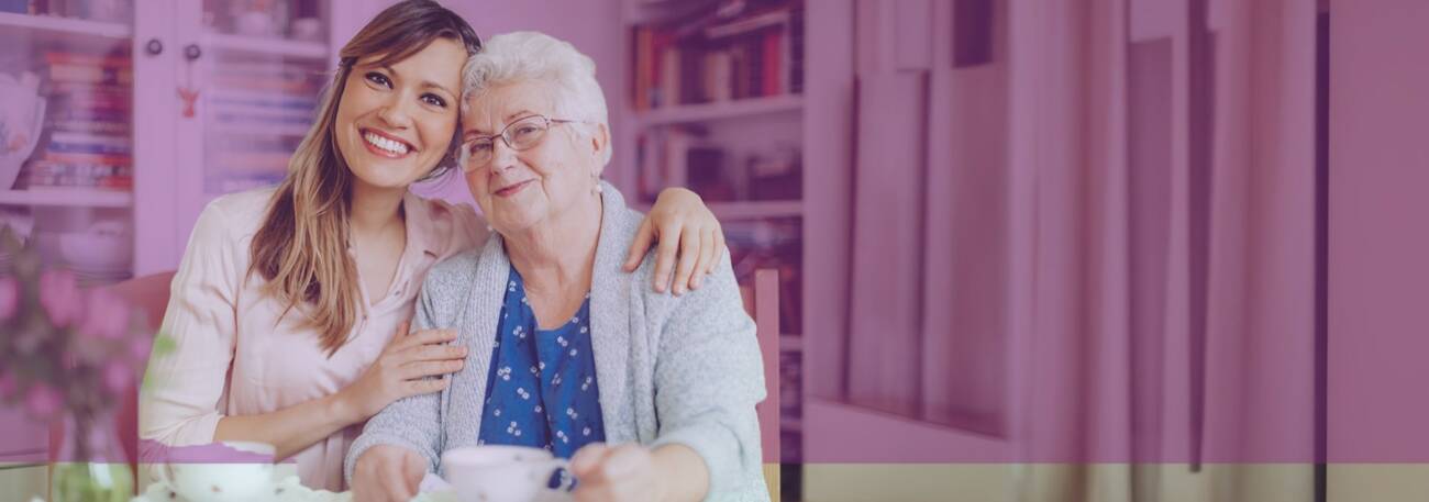 Young woman with elderly woman smiling